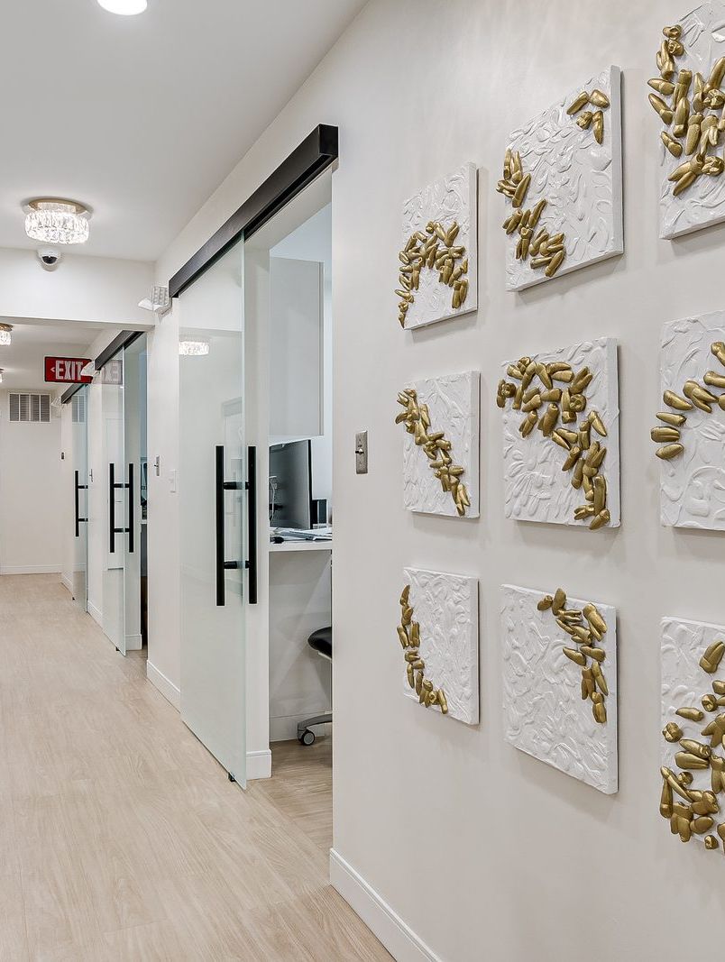 hallway-gold-botanical-panels-matawan-dental-galleria Hallway at Matawan Dental Galleria with gold botanical wall panels and light wood floors